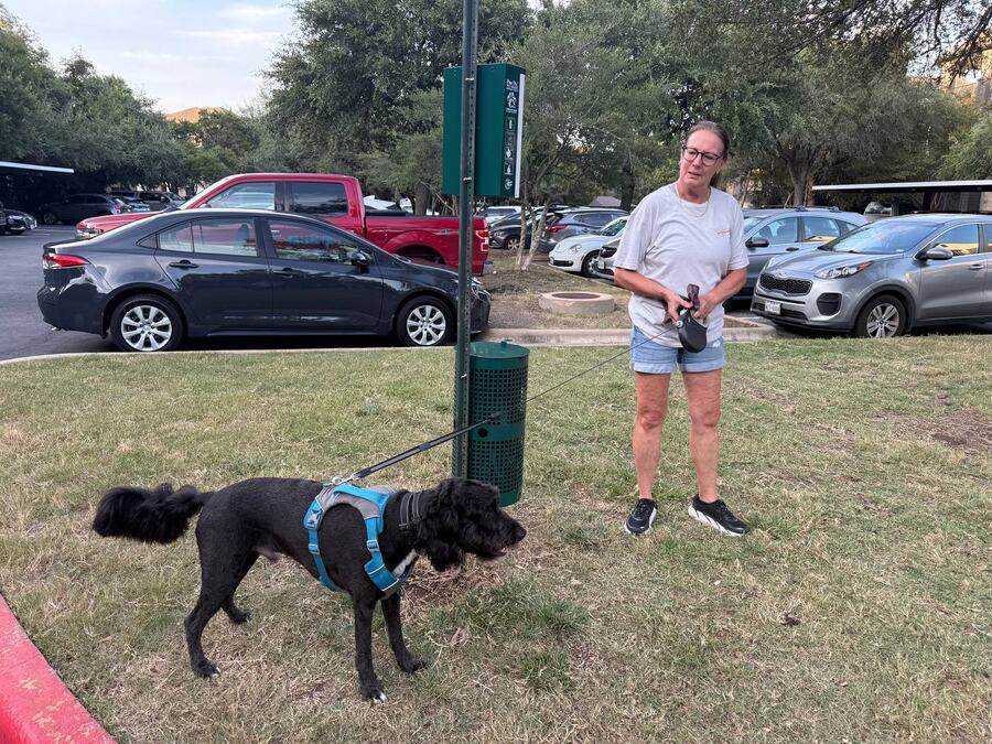Carol standing with Rudy during an outdoor neighborhood walk